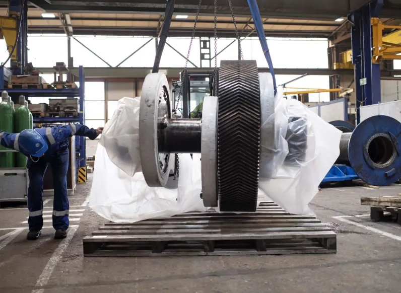 Exuocova’s API-certified workshop scene with a large black-and-silver drilling equipment assembly on a steel base for remote technical support 24/7.